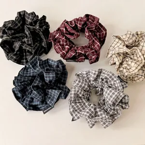 Five-piece set of retro plaid fabric scrunchies with handmade labels on white background