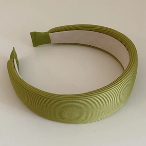 Detail of green ribbed knit headband with thick sponge padding and non-slip lining