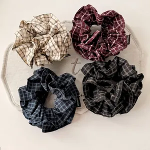 Set of four vintage plaid fabric scrunchies in white, burgundy, navy, and grey colors
