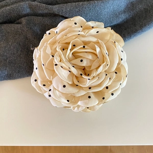 Detailed close-up of French vintage leopard polka dot rose hair claw clip