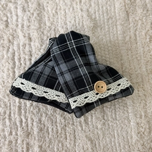 Detail view of retro plaid fabric accessories with delicate lace trim and wood button