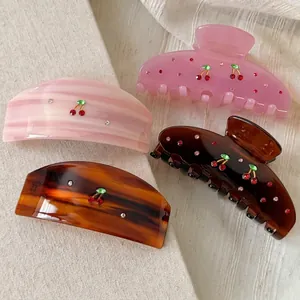 Elegant acetate cherry hair clips set with red rhinestones in four stylish colors
