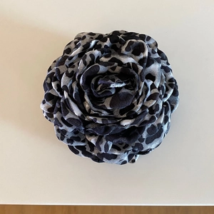 Detailed top view of leopard print fabric rose hair claw clip with vintage layers
