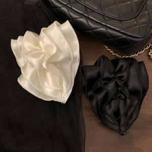 Elegant satin flower banana clips in cream and black with a sophisticated layered design