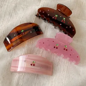 Elegant acetate cherry hair claw clips and barrettes set with red rhinestone embellishments
