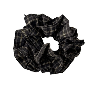 Classic black and white checkered fabric scrunchie with a textured vintage design