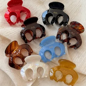 Elegant multi-colored acetate pumpkin hair claws with gold Borrette La France lettering