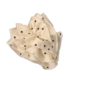 Elegant off-white satin banana hair clip with black polka dots and tiered ruffle design