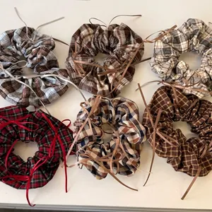 Set of six ballet-style plaid scrunchies with elegant ribbon bows in various autumn colors