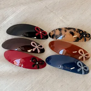 Set of six colorful acetate bow hair clips with rhinestones in an oval spring design