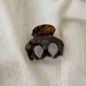 Detail of tortoiseshell acetate claw clip with gold Barrette La France text engraving