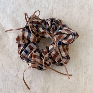 Plaid scrunchie with brown ribbon bows in a retro balletcore hair accessory style