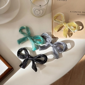 Set of four glossy organza bow hair clips in yellow, blue, grey, and black colors