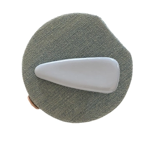 Grey-blue glossy patent leather waterdrop hair clip on grey denim pad minimalist style
