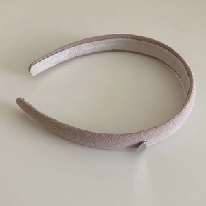 Detail view of pink knit headband showing anti-slip velvet and silver heart pendant