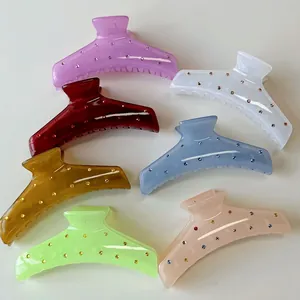 Set of seven colorful rhinestone hair claws in translucent acrylic for versatile hair styling