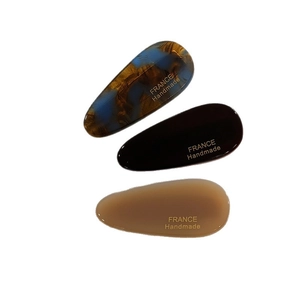 Three-piece set of waterdrop-shaped tortoiseshell hair clips in blue, brown, and tan tones