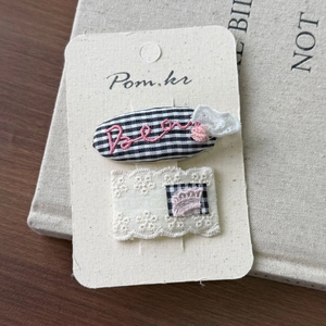 Detailed shot of Korean style hair clips with black and white patterns on display card