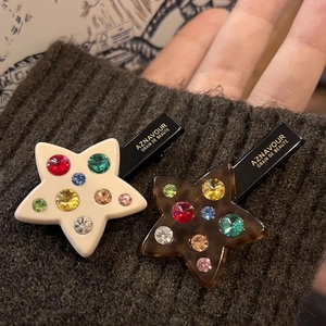 Star-shaped duckbill hair clips with colorful rhinestones in cream and tortoiseshell