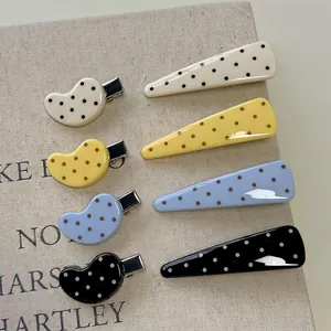Cute polka dot hair clip set in cream, yellow, blue and black for a minimalist summer look