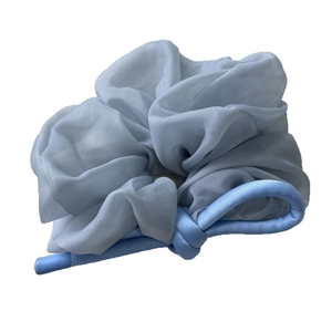 Elegant light blue sheer organza scrunchie with silky ribbon bow for high-end ponytail style