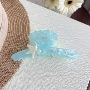 Light blue shell hair claw with starfish and rhinestones in acetate marble finish