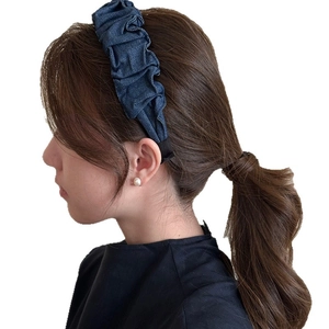 Wide pleated denim headband in navy blue color on model for high cranial top look