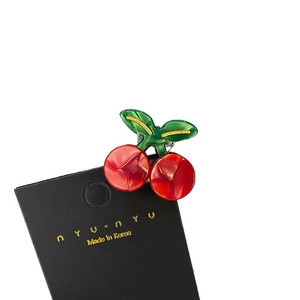 Mini acetate cherry hair claw clip with green leaves and glitter detail on card