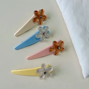 Elegant set of 4 resin floral hair clips in cream, blue, pink, and yellow summer colors