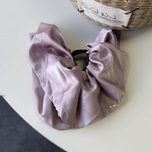 Detail of dusty pink satin fabric texture on a large elegant hair claw clip accessory