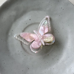 Macro shot of French acetate butterfly hair clip with pink pearlescent marble texture