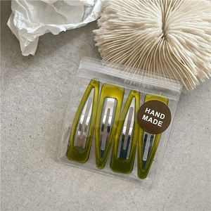 Set of 4 olive green resin BB hair clips in hand made packaging on a textured background