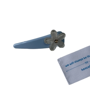 Elegant Morandi blue flower hair clip with grey petals and brown crystal on white background