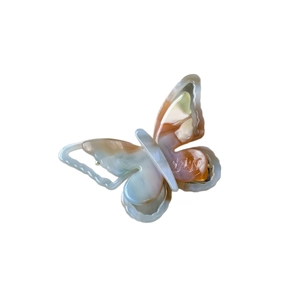 French iridescent acetate butterfly hair clip with colorful marble texture on white background