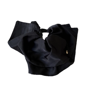 Elegant large black fabric bow hair claw clip with golden metal detail on white background