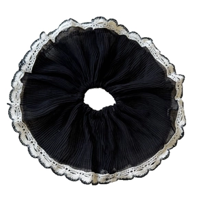 Elegant black pleated chiffon scrunchie with white lace trim for hair styling