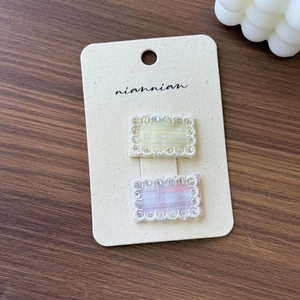 Detail of Korean style lace-edged plaid and striped fabric hair clips on display card