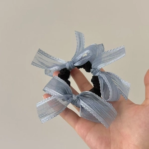 Black elastic hair scrunchie with light blue lace bows and delicate ribbon details