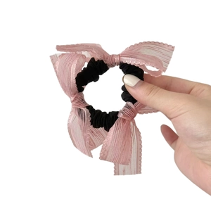 Handheld sweet pink lace bow scrunchie with transparent stripes and black elastic hair tie