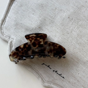 Detail of tortoiseshell acetate hair claw clip with gold Barrette La France lettering