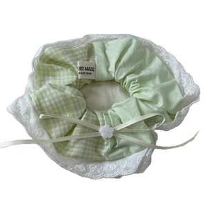 Green plaid scrunchie with white lace edges and a small ribbon bow hair accessory