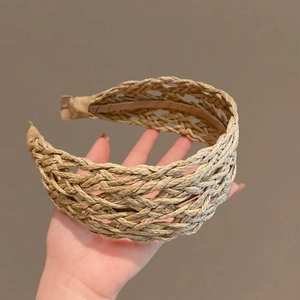 Detail of hand-woven raffia headband featuring hollow-out braided texture and smooth inner lining