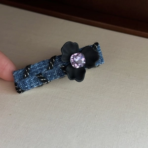 Denim fabric floral hair clip with black resin flower and purple crystal centerpiece