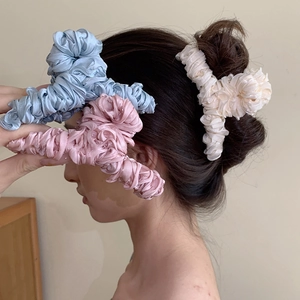Elegant pleated fabric hair claw clips in light blue, pink and cream for women