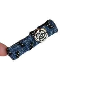 Retro denim hair clip with silver 3D flower and woven edge in a minimalist style