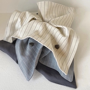 Minimalist striped scrunchie hair ties in neutral tones with elegant heart button details