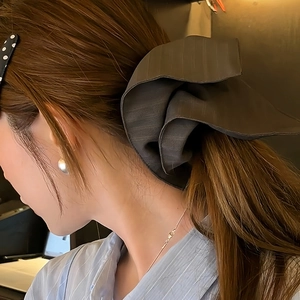 Elegant dark grey oversized striped bow hair scrunchie for a stylish ponytail look