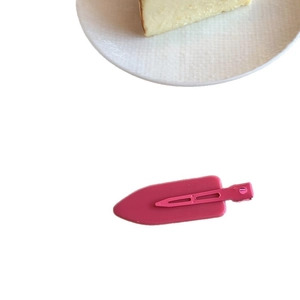 Sweet rose pink candy-colored hair clip with smooth finish and metal spring on a white surface