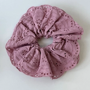 Detail of dusty pink scalloped cotton hair scrunchie with delicate eyelet embroidery