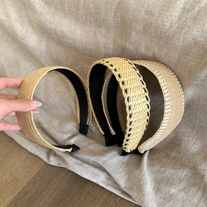 Set of four woven straw headbands in natural khaki with various bohemian braid patterns